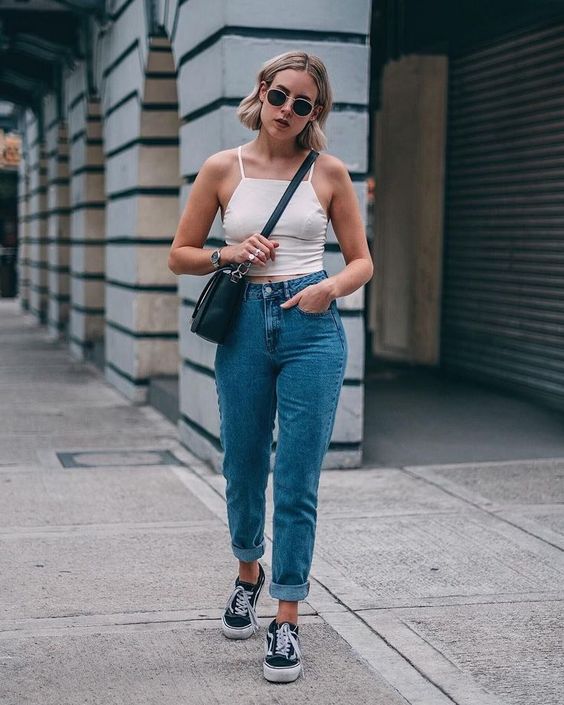 Pairing a tank top and jeans with Vans sneakers makes for a more stylish look.