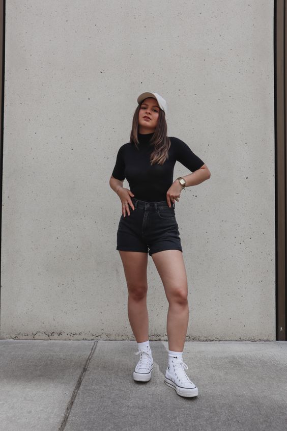 Turtleneck and black denim shorts create a youthful look